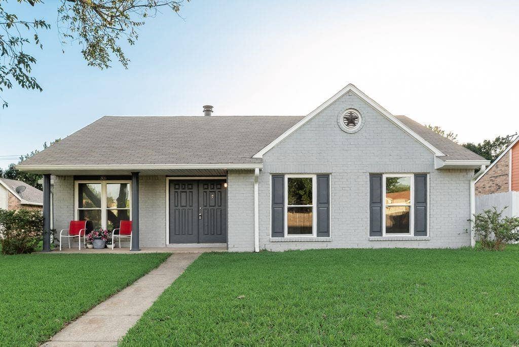 316 Matterhorn Street, Cedar Hill, TX 75104 Single-story residence featuring a gray brick facade and a prominent front gable with a decorative medallion