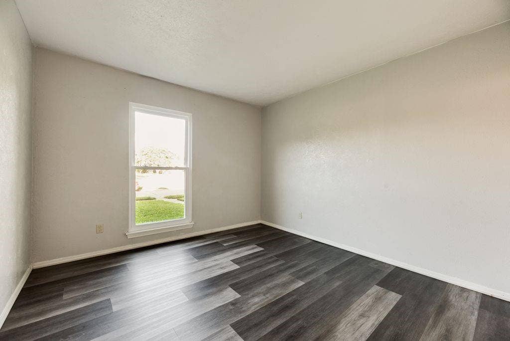 316 Matterhorn Street, Cedar Hill, TX 75104 Room featuring dark wood-finish flooring, light neutral walls, and a white-framed window