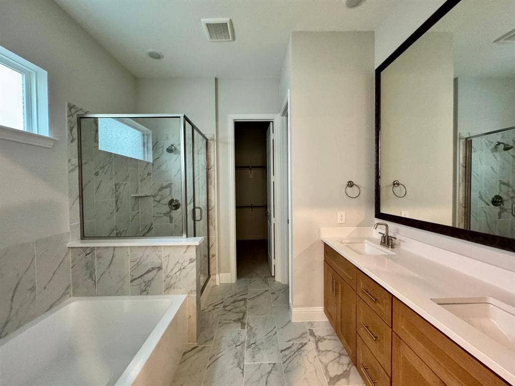 2930 Eleanor Drive, Prosper, TX 75078 Full bath with a garden tub, marble finish floors, a marble finish shower, double vanity, and a walk in closet