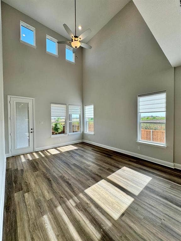 2930 Eleanor Drive, Prosper, TX 75078 Unfurnished living room with wood finished floors, ceiling fan, and a towering ceiling