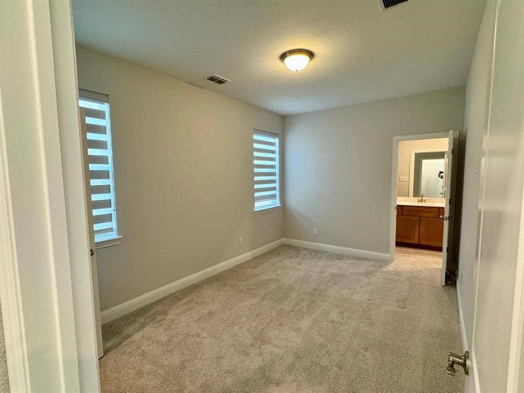 2930 Eleanor Drive, Prosper, TX 75078 Unfurnished bedroom with light carpet and a textured ceiling