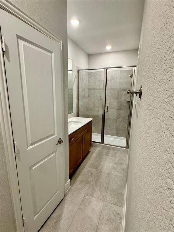 2930 Eleanor Drive, Prosper, TX 75078 Full bathroom with a textured wall, vanity, and a stall shower