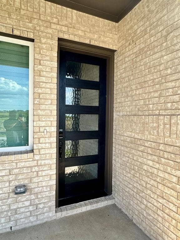 2930 Eleanor Drive, Prosper, TX 75078 View of exterior entry featuring brick siding