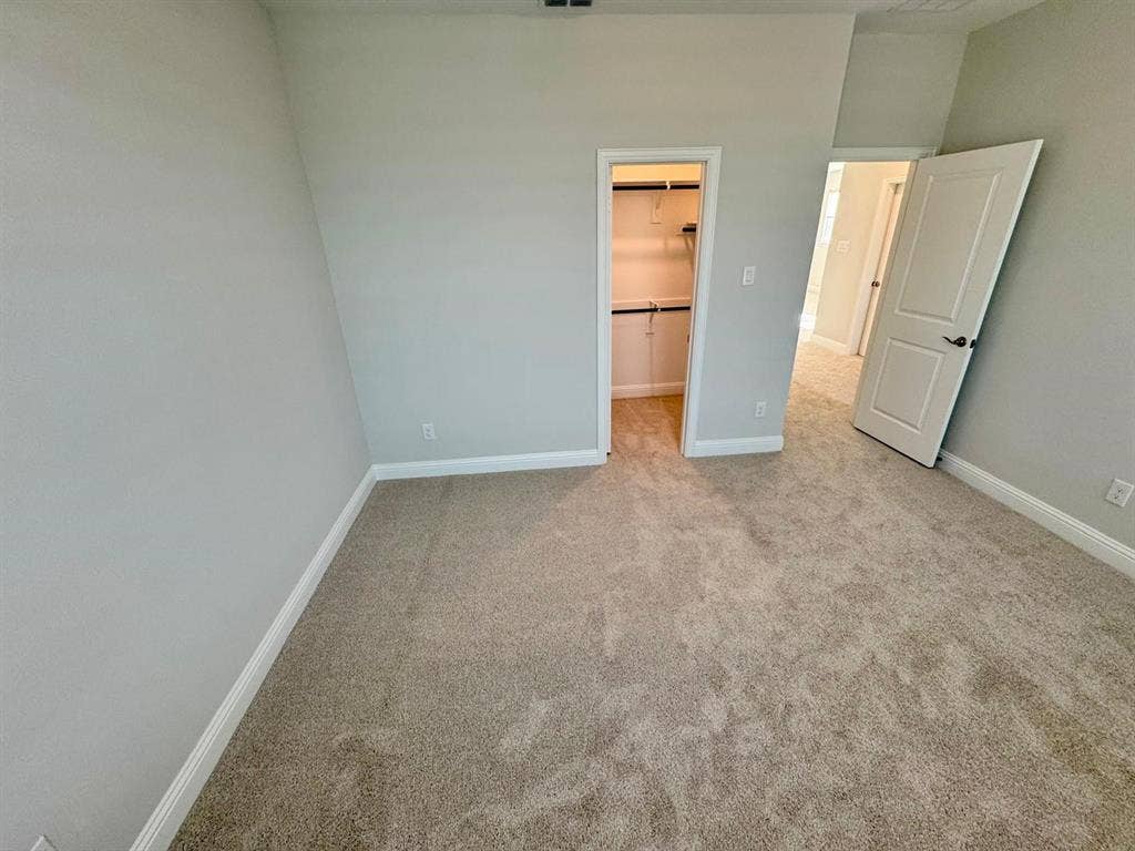 2930 Eleanor Drive, Prosper, TX 75078 Unfurnished bedroom featuring carpet flooring and a walk in closet