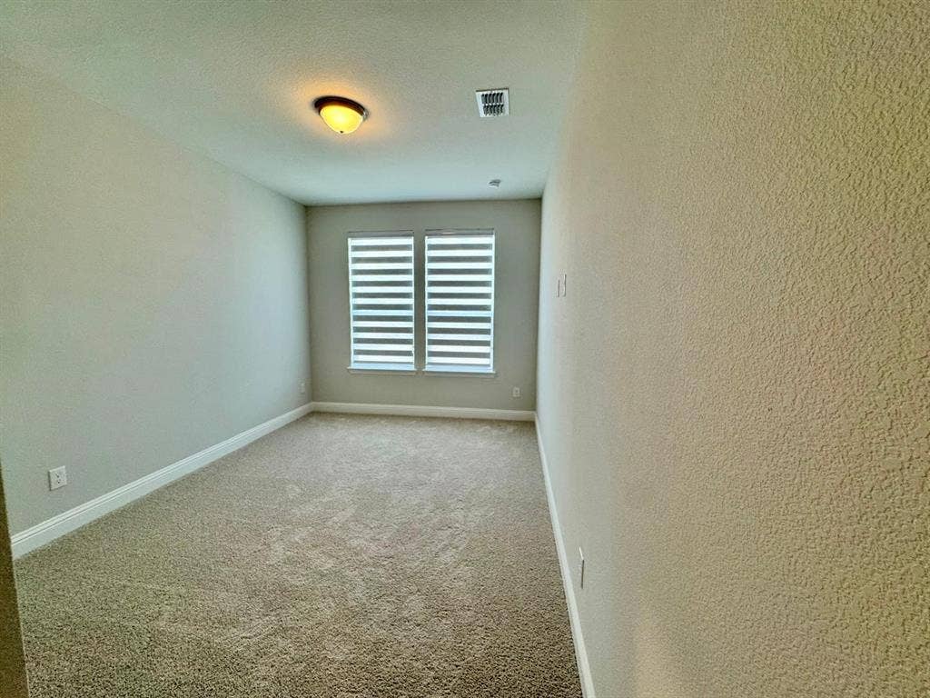 2930 Eleanor Drive, Prosper, TX 75078 Carpeted empty room with a textured ceiling and a textured wall