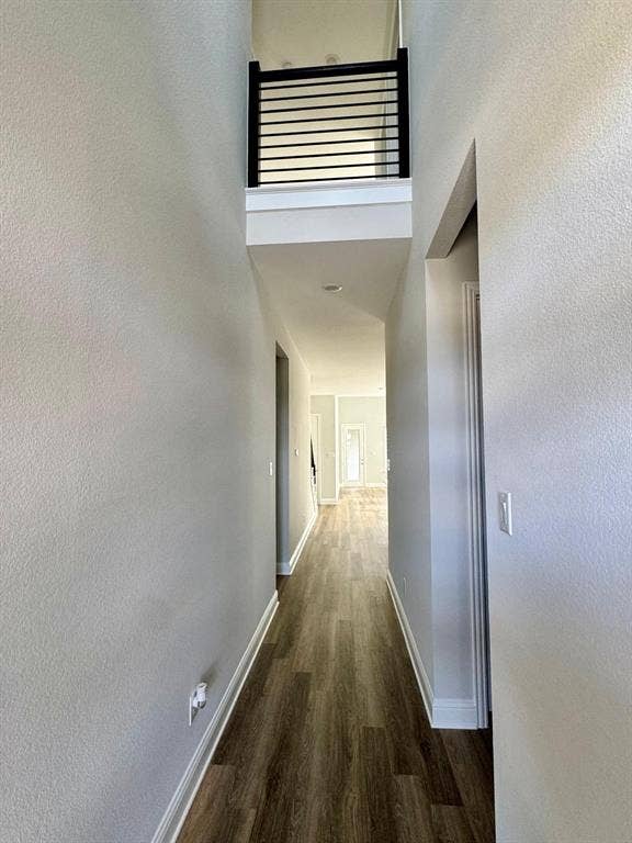 2930 Eleanor Drive, Prosper, TX 75078 Hallway with a high ceiling, wood finished floors, and a textured wall