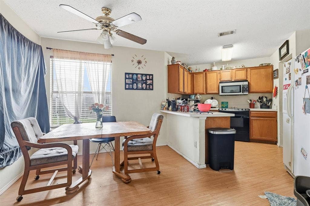 6406 Nicole Way, Arlington, TX 76002 Dining area next to kitchen with ceiling fan and wood-look flooring