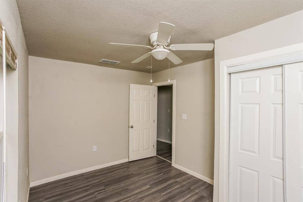 2402 Summer Avenue, Waco, TX 76708 Room featuring wood-finish flooring, neutral wall paint, and a white ceiling fan with light kit