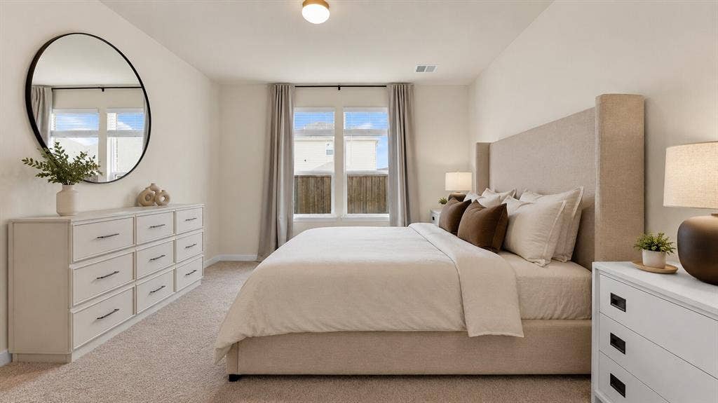 707 Indigo Road, Princeton, TX 75407 Spacious bedroom featuring light-colored walls, carpet flooring, a ceiling-mounted light fixture, and large windows with blinds and curtains