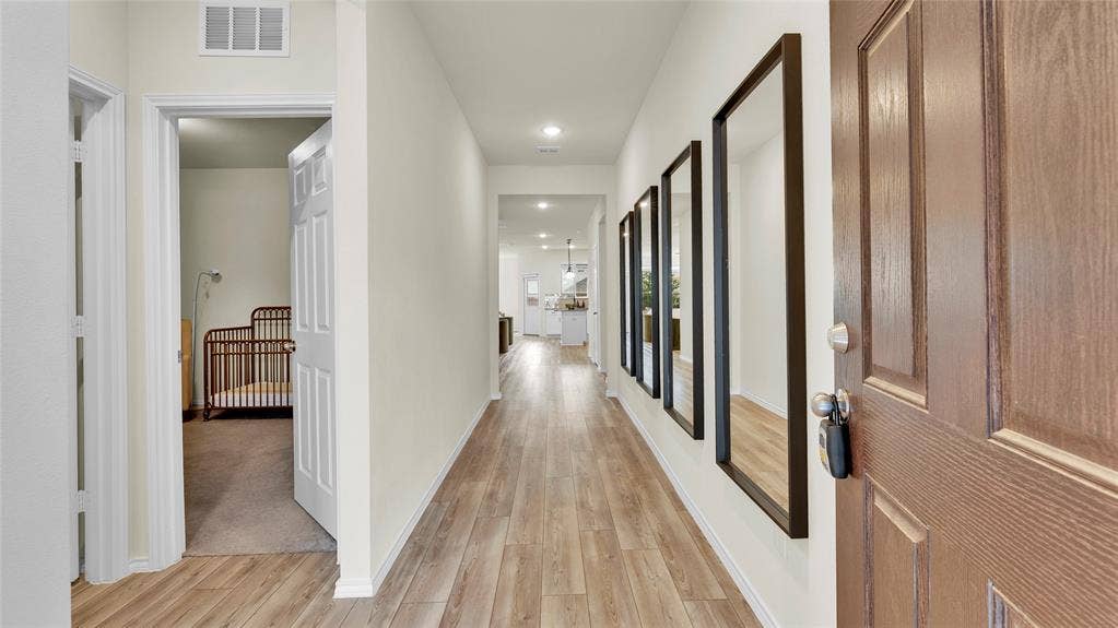 707 Indigo Road, Princeton, TX 75407 Entryway featuring wood-finish flooring, recessed lighting, and a paneled wooden door