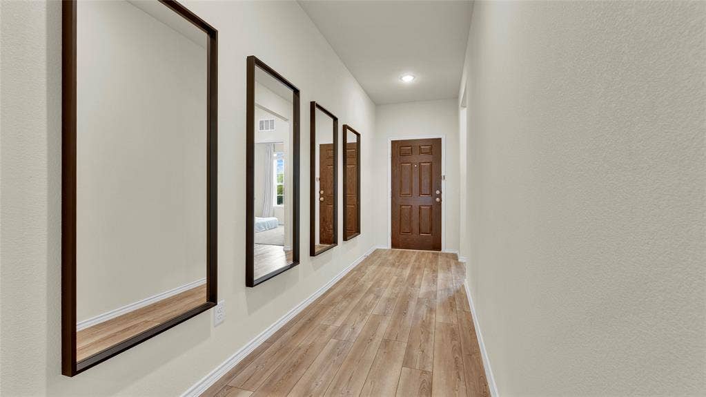 707 Indigo Road, Princeton, TX 75407 Entryway featuring wood-finish flooring, light neutral wall tones, and a paneled entry door