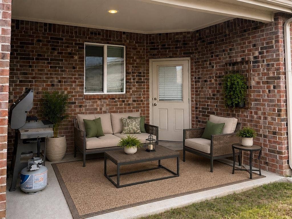 707 Indigo Road, Princeton, TX 75407 Covered patio featuring brick exterior walls and concrete flooring