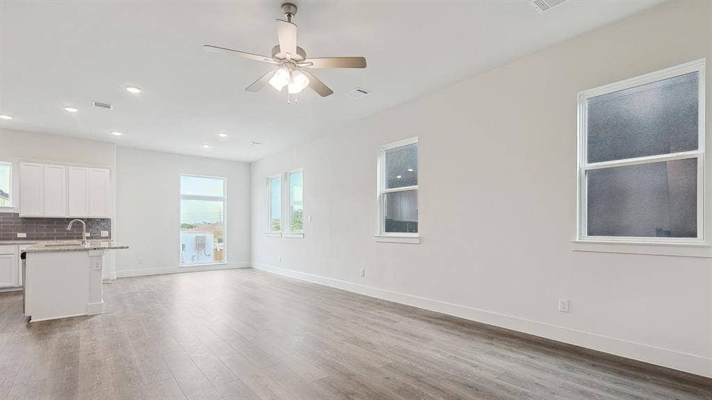 Open-concept living area with wood-finish flooring