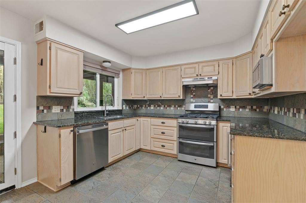 Great kitchen workspace overlooks the back yard