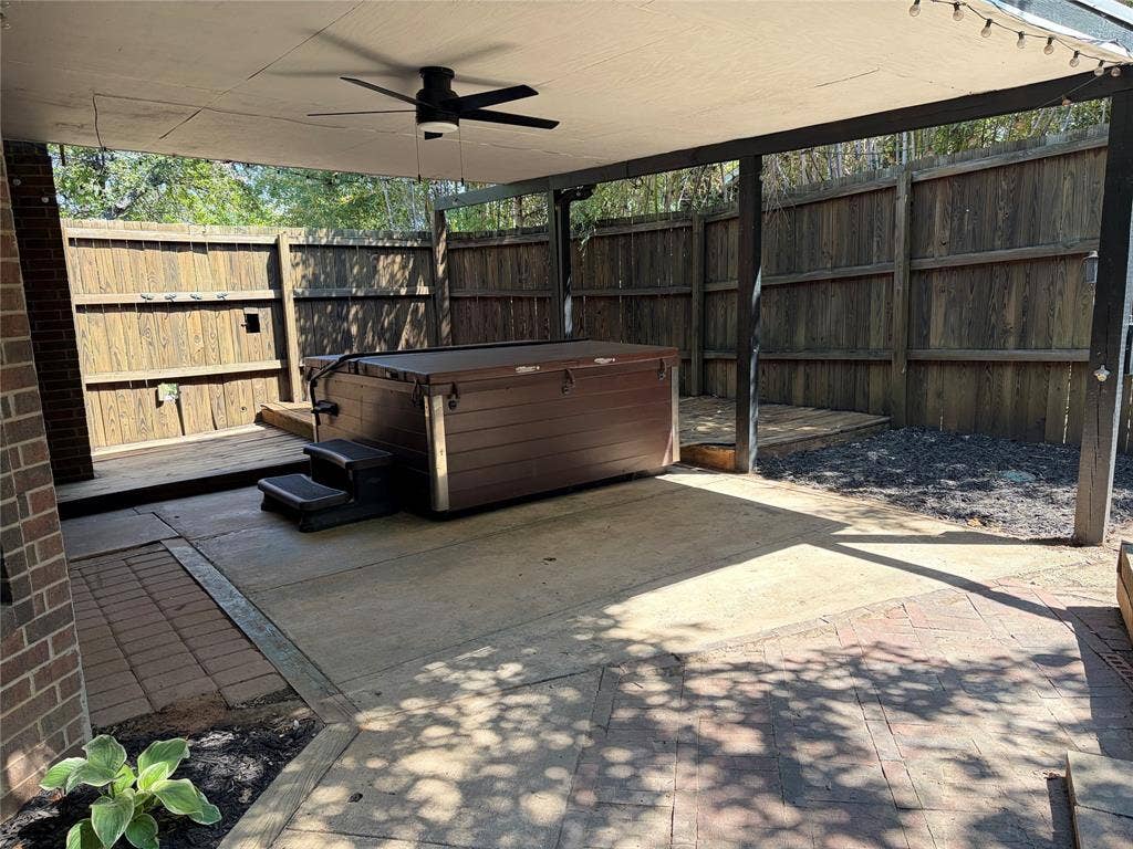 Covered patio with hot tub and plenty of space to entertain