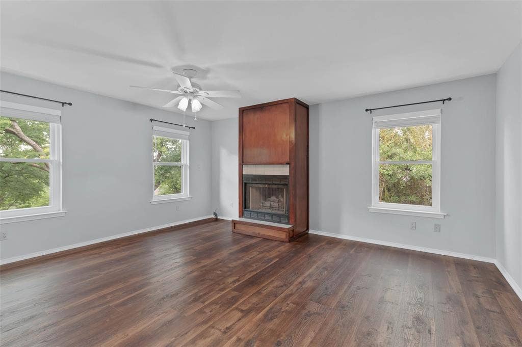 Large primary bedroom with fireplace upstairs with lots of windows feels like a treehouse
