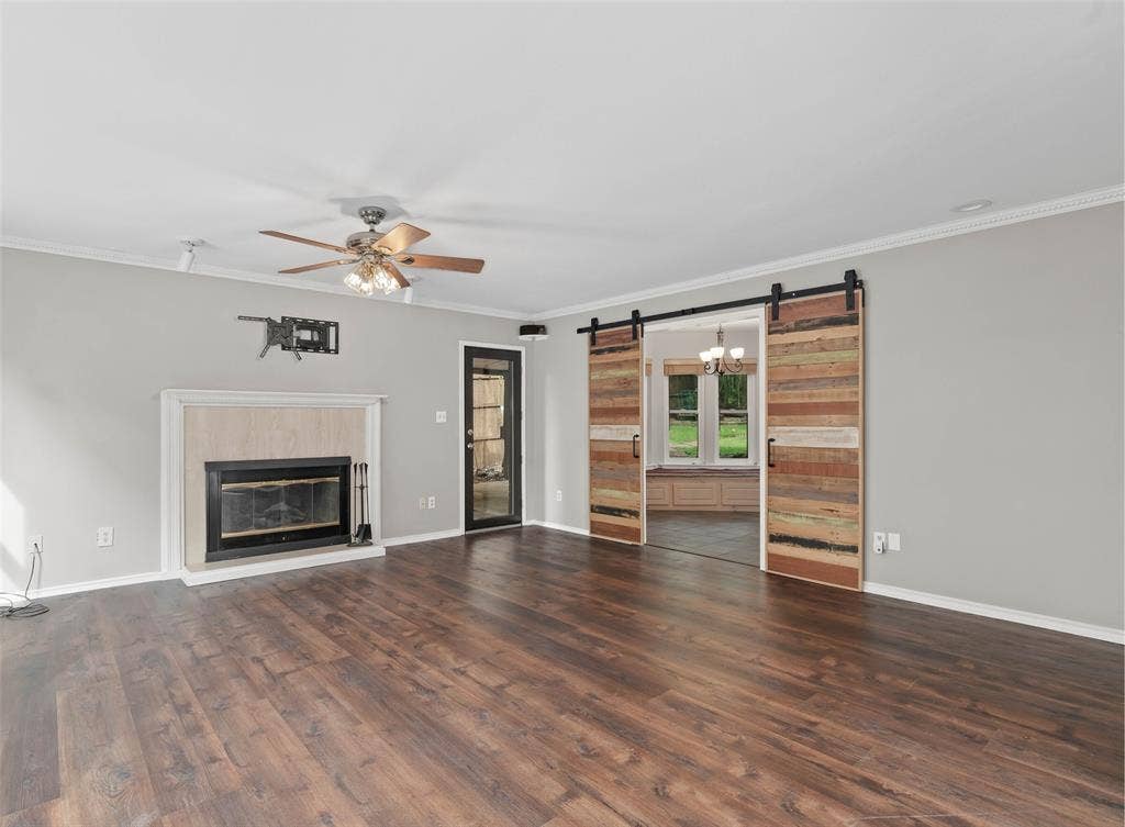 Large living area with unique barn doors leading to the kitchen and breakfast room