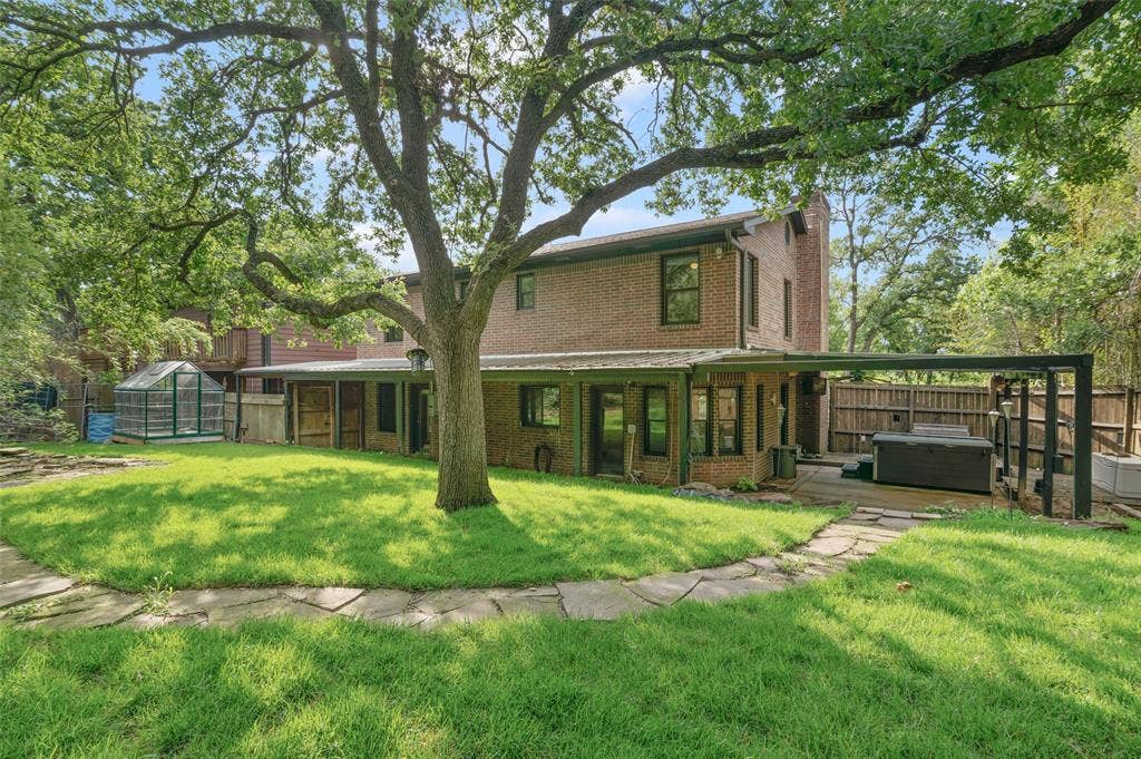 What a great back yard! Secluded backyard, large grassy area and a covered patio with hot tub.