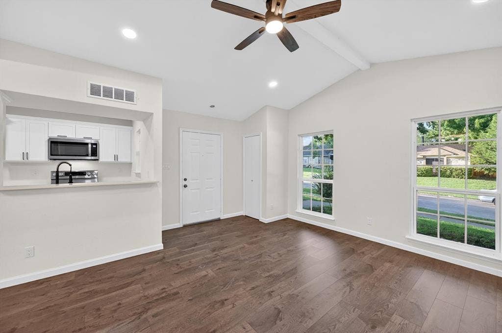 428 Dollins Street, Cedar Hill, TX 75104 Living area featuring wood-finish flooring, a vaulted ceiling, and a ceiling fan with integrated lighting