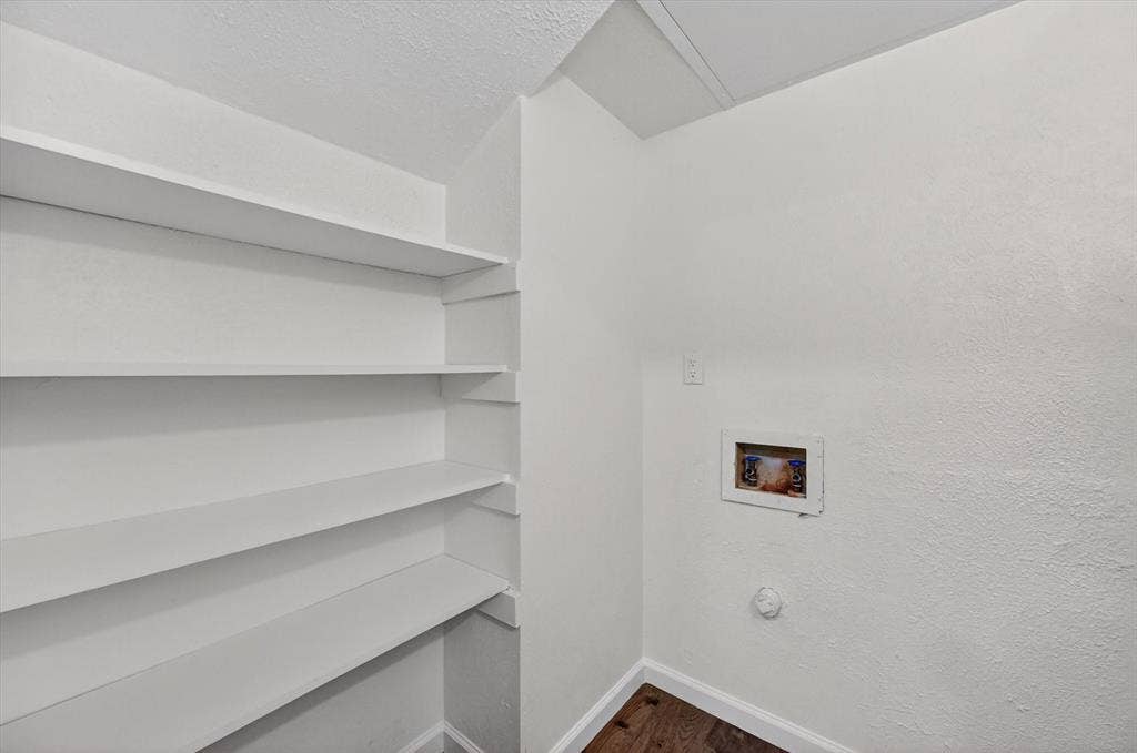 428 Dollins Street, Cedar Hill, TX 75104 Utility area with built-in shelving, washer hookup, and wood-finish flooring
