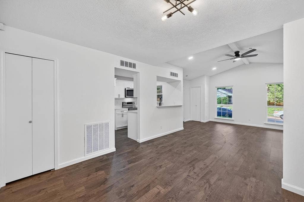 428 Dollins Street, Cedar Hill, TX 75104 Spacious living area featuring wood-finish flooring, vaulted ceiling, and recessed lighting