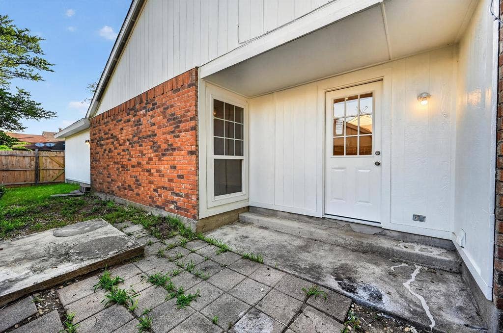 428 Dollins Street, Cedar Hill, TX 75104 Exterior featuring a brick facade and white vertical siding