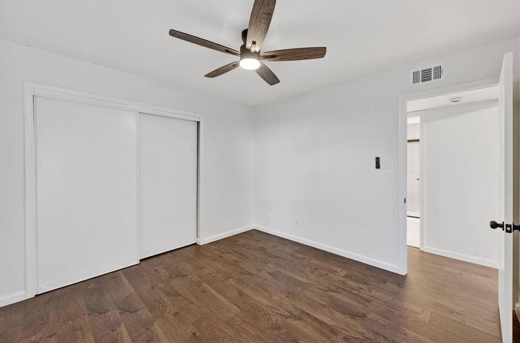 428 Dollins Street, Cedar Hill, TX 75104 Bright interior space featuring wood-finish flooring, white walls, and a modern ceiling fan with integrated lighting