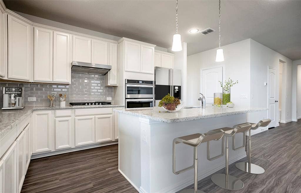 445 Avian Way, Godley, TX 76044 *Virtual Representation - Abundant cabinet space and lovely eat-in bartop island