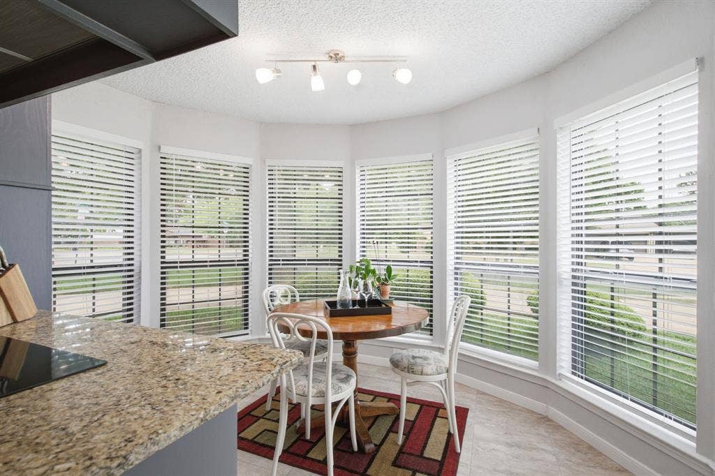 521 W Louella Drive, Hurst, TX 76054 Another view of the eat in kitchen surrounded by windows.