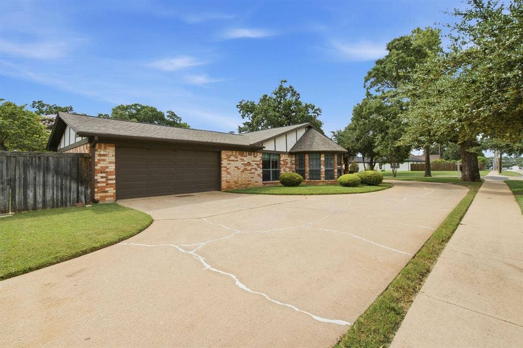 521 W Louella Drive, Hurst, TX 76054 Extra parking and side entrance two car garage.