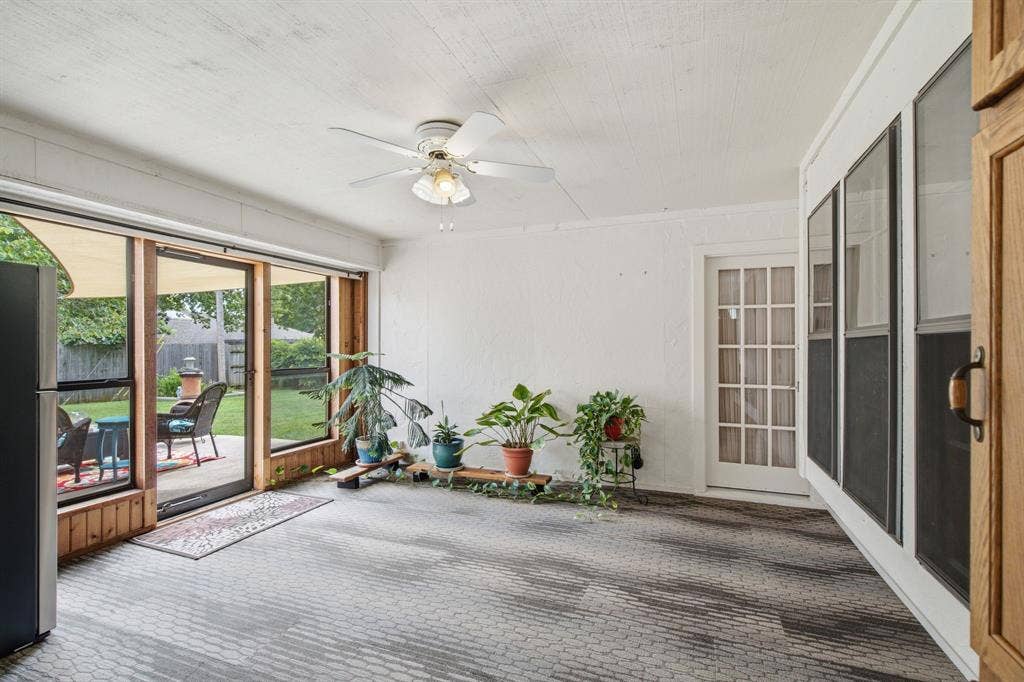 521 W Louella Drive, Hurst, TX 76054 Enclosed sunroom with glass storm door and doors leading into the primary bedroom and from the secondary, living room, Extra storage cabinets and perfect place for an extra refrigerator or freezer. While not airconditioned, when they leave the doors open from the other rooms, it stays pretty cool.