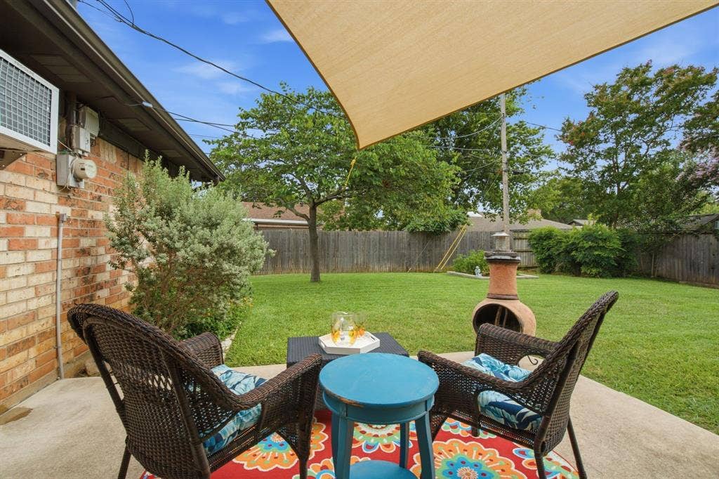 521 W Louella Drive, Hurst, TX 76054 Enjoy a relaxing drink with a cloth sail to shade the patio.