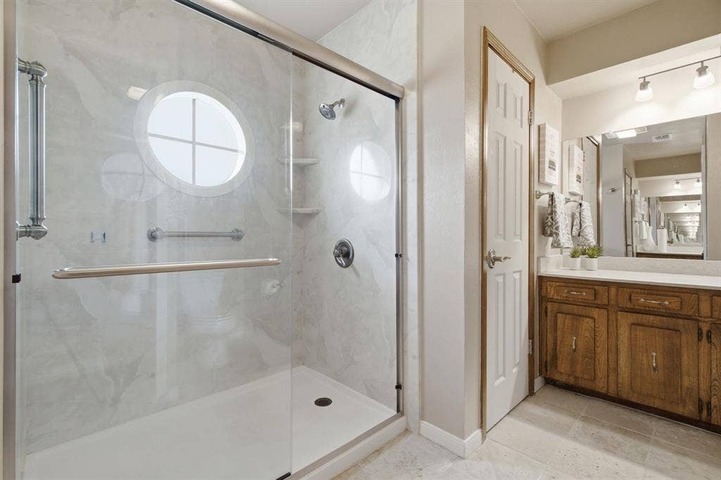 521 W Louella Drive, Hurst, TX 76054 Primary bathroom with an oversized shower and two separate vanities and closets.