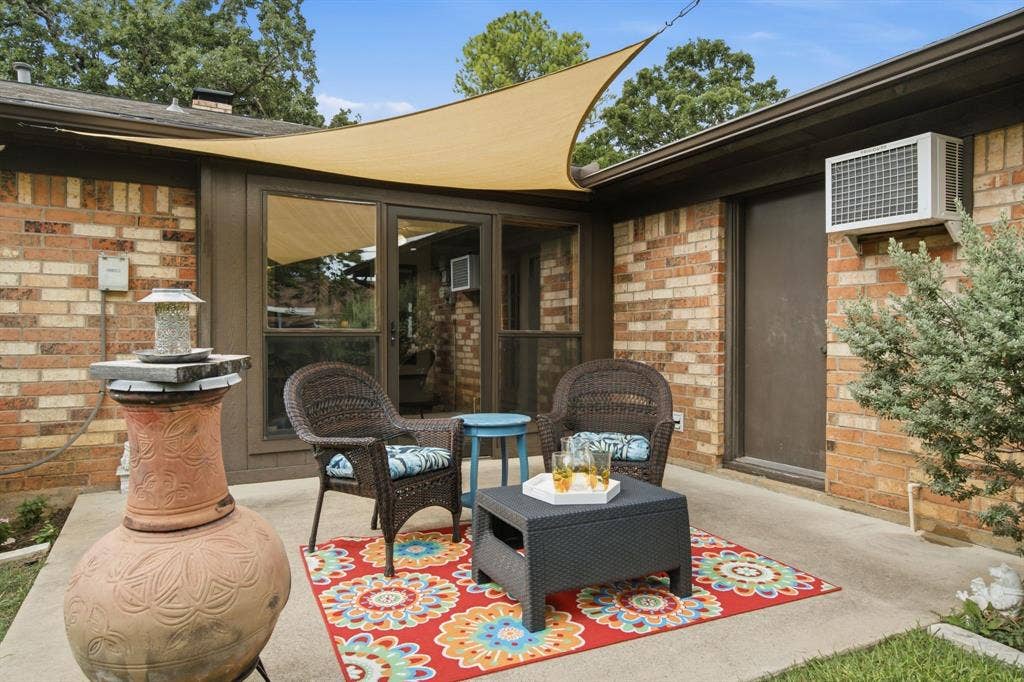 521 W Louella Drive, Hurst, TX 76054 Another view of the patio off of the sunroom. Notice that there is an AC unit for the garage. Door to the right leads to the garage.