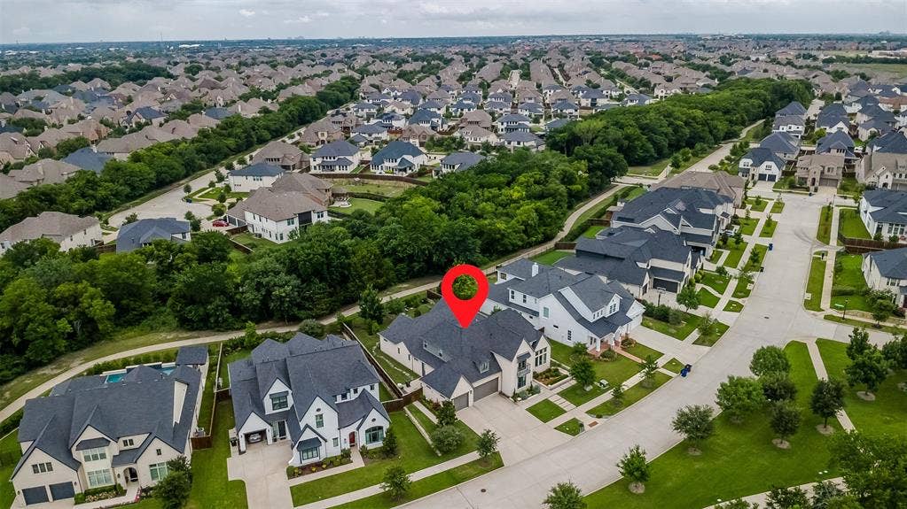 8138 Edgefield Court, Frisco, TX 75035 Contemporary suburban residence featuring a multi-gabled roofline, light-toned exterior, attached garage, and manicured landscaping