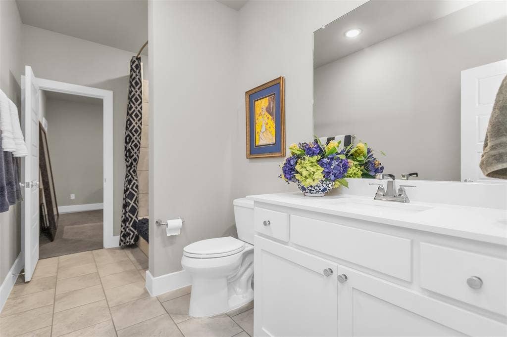 8138 Edgefield Court, Frisco, TX 75035 Bathroom with white vanity, single sink, and large wall-mounted mirror