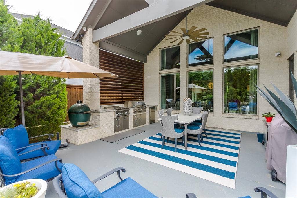 8138 Edgefield Court, Frisco, TX 75035 Covered patio featuring an outdoor kitchen with built-in grills, a dedicated cooking station, and ample counter space