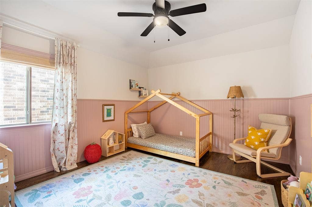7405 Collin Mckinney Parkway, McKinney, TX 75070 Secondary bedroom with custom wall paneling and hardwood floors