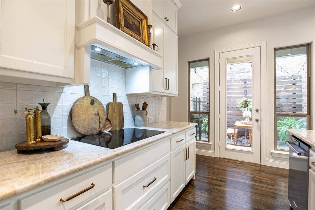 7405 Collin Mckinney Parkway, McKinney, TX 75070 Kitchen with updated white cabinetry and built-in induction stove