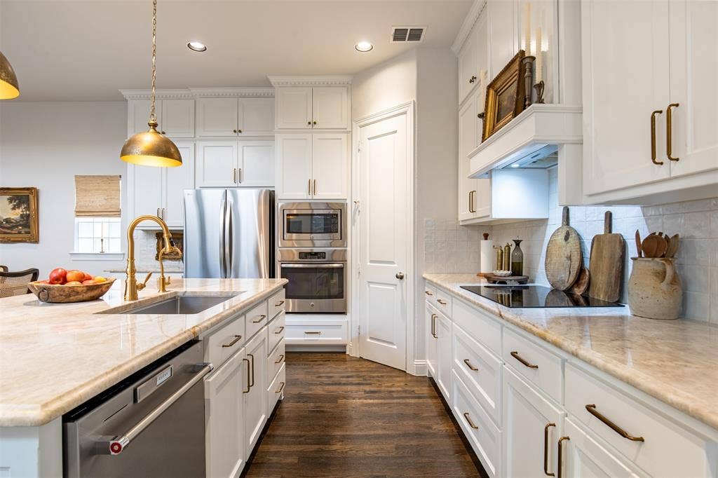 7405 Collin Mckinney Parkway, McKinney, TX 75070 Kitchen with updated white cabinetry and built-in induction stove