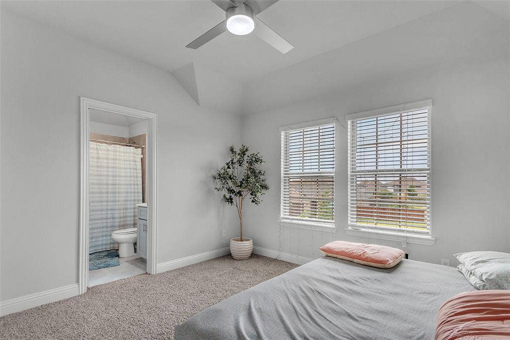 3708 Jan Camille Court, Celina, TX 75009 Carpeted bedroom with ensuite bath, vaulted ceiling, and ceiling fan