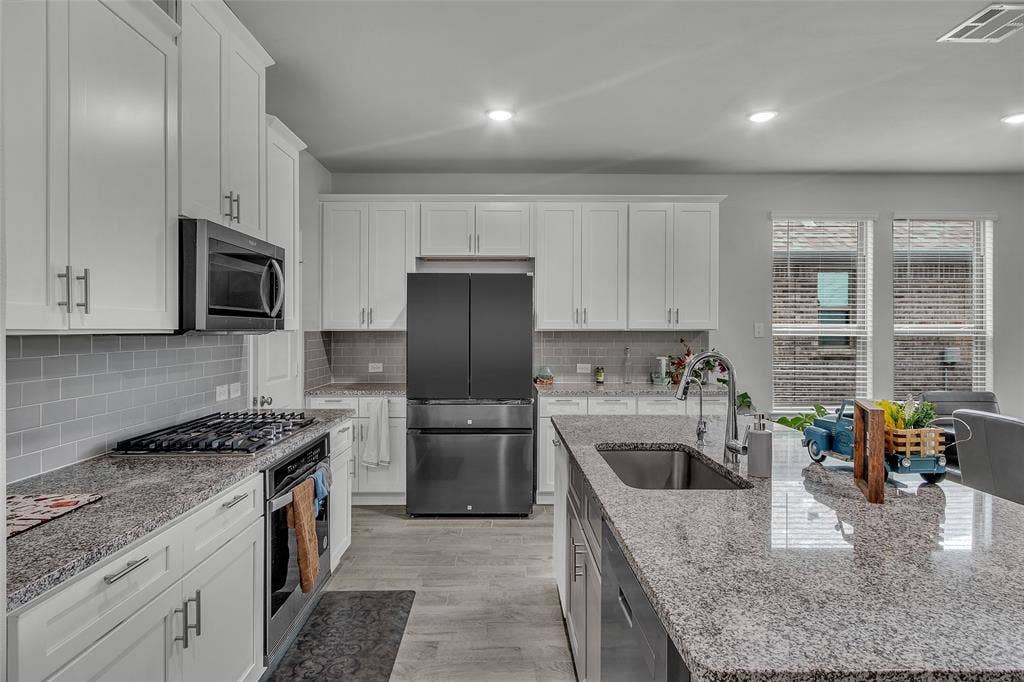 3708 Jan Camille Court, Celina, TX 75009 Kitchen featuring a kitchen island with sink, appliances with stainless steel finishes, plenty of natural light, and sink