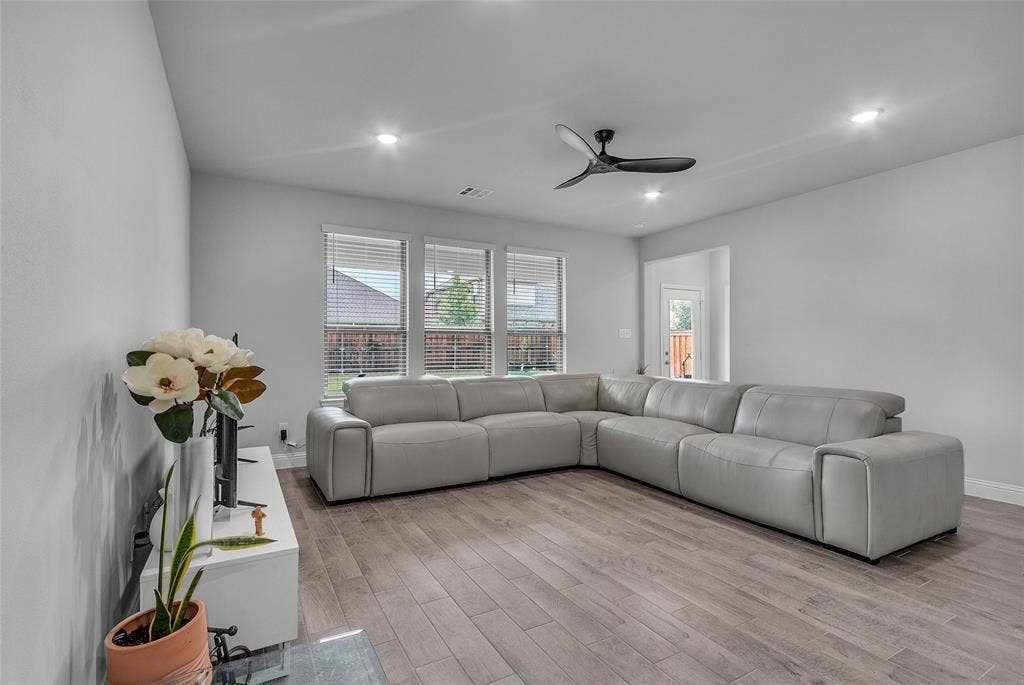 3708 Jan Camille Court, Celina, TX 75009 Living room with plenty of natural light, ceiling fan, light hardwood / wood-style flooring, and a fireplace