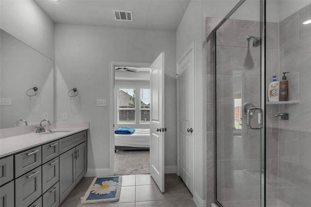 3708 Jan Camille Court, Celina, TX 75009 Bathroom with tile patterned flooring, vanity, and a shower with shower door