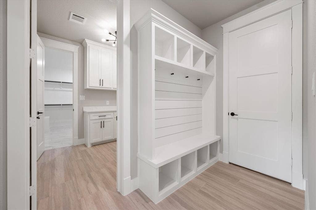 6610 Waggoner Way, Midlothian, TX 76065 Built-in white mudroom bench with cubby storage, shiplap backing, and coat hooks