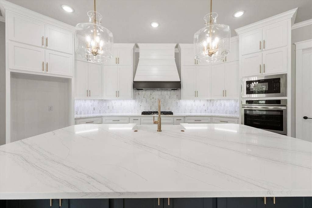 6610 Waggoner Way, Midlothian, TX 76065 Kitchen island with a quartz countertop and integrated sink
