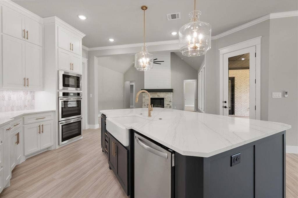 6610 Waggoner Way, Midlothian, TX 76065 Kitchen island with a farmhouse sink and gold-tone faucet