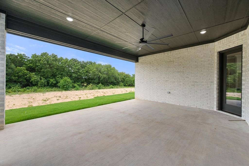 6610 Waggoner Way, Midlothian, TX 76065 Expansive covered patio featuring a concrete surface, white brick wall, and a dark wood-finish ceiling with recessed lighting