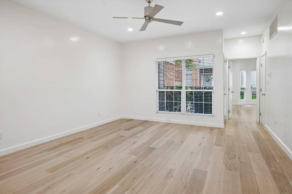 12680 Hillcrest Road, #1109, Dallas, TX 75230 Large living area with beautiful floors. This room overlooks the patio.