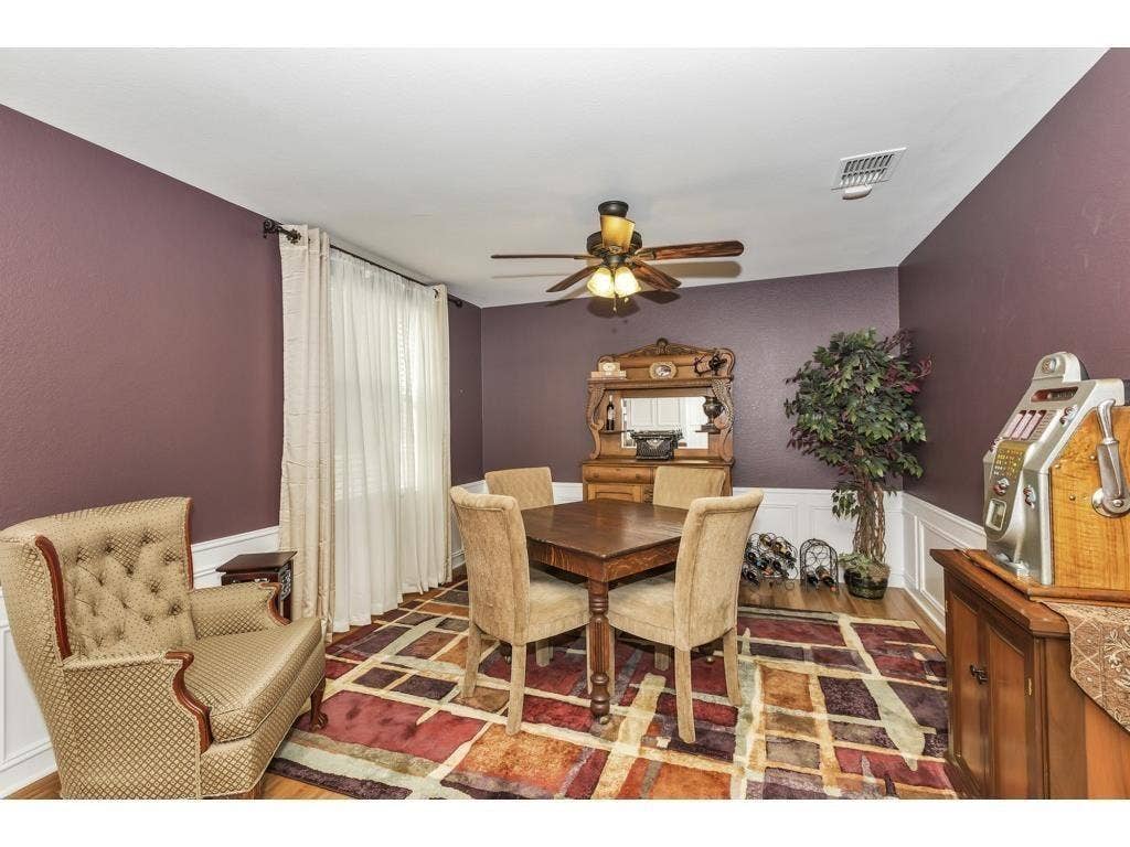 2912 Lake Terrace Drive, Wylie, TX 75098 Dining area with wood-finish flooring, white crown molding, and a ceiling fan with integrated lighting